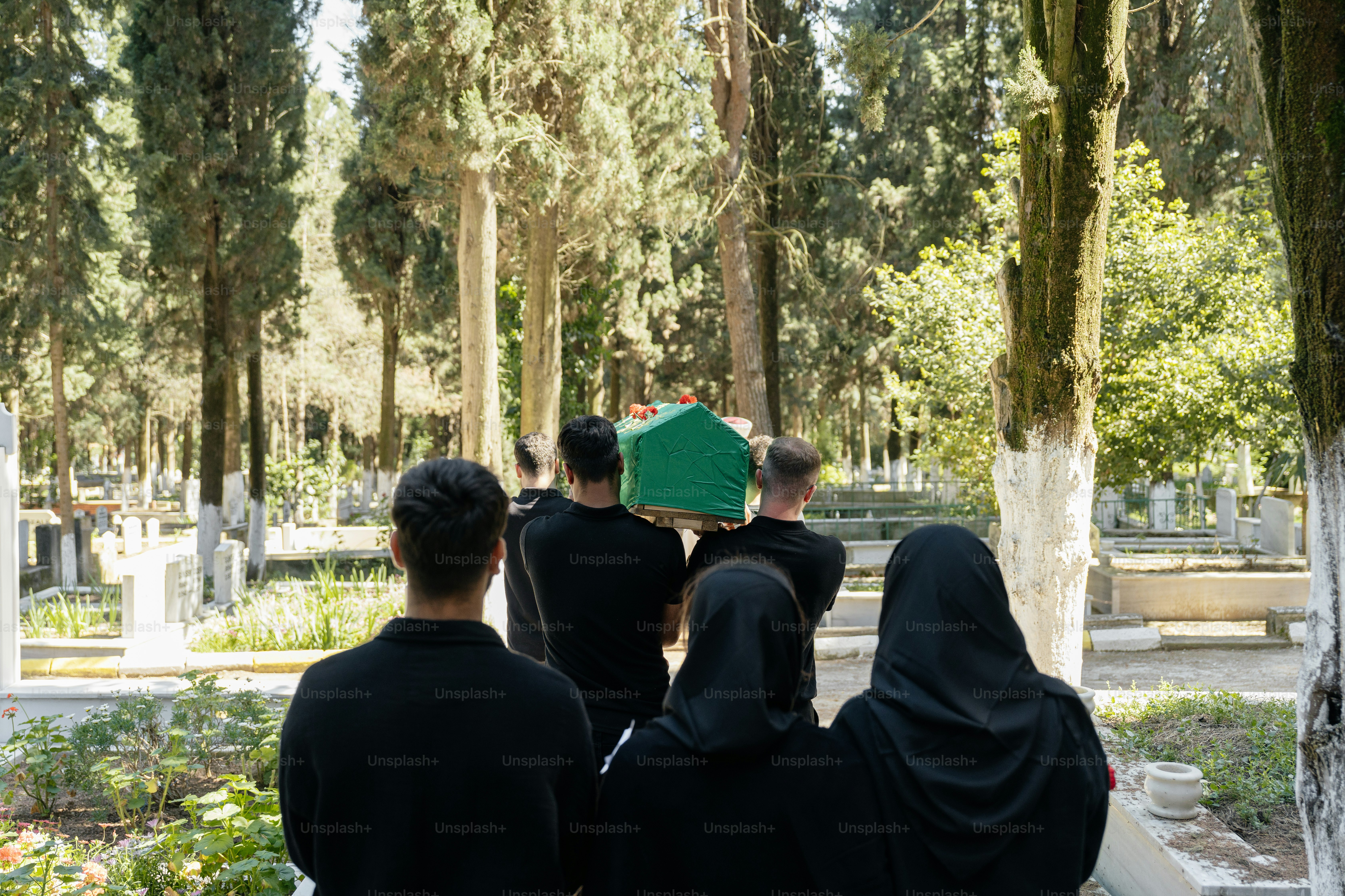 a group of people sitting on a bench in a park