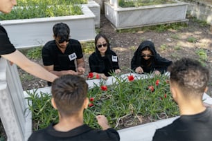 a group of people standing around a garden