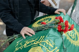 a close up of a person placing flowers on a table