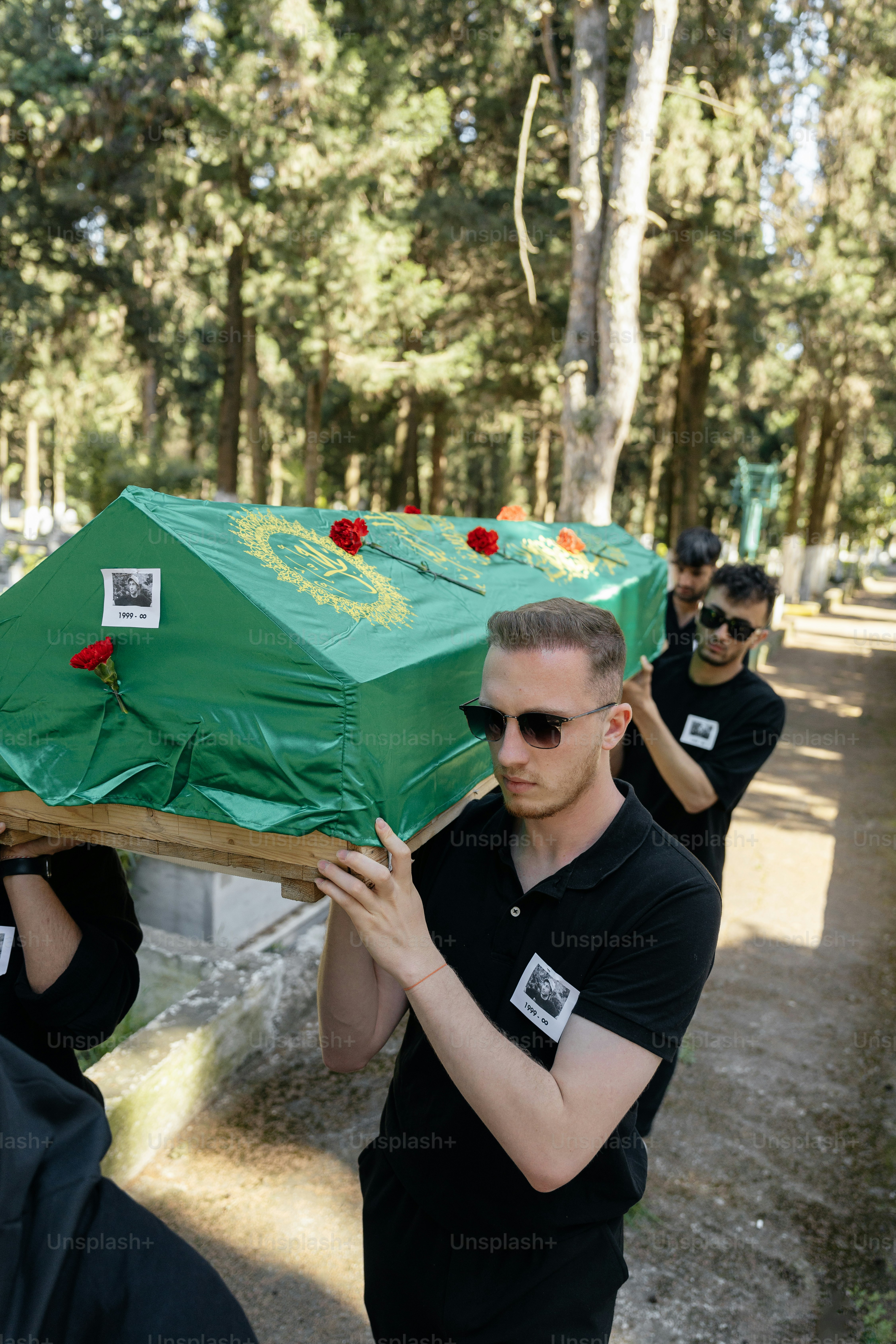 a group of people carrying a large green object