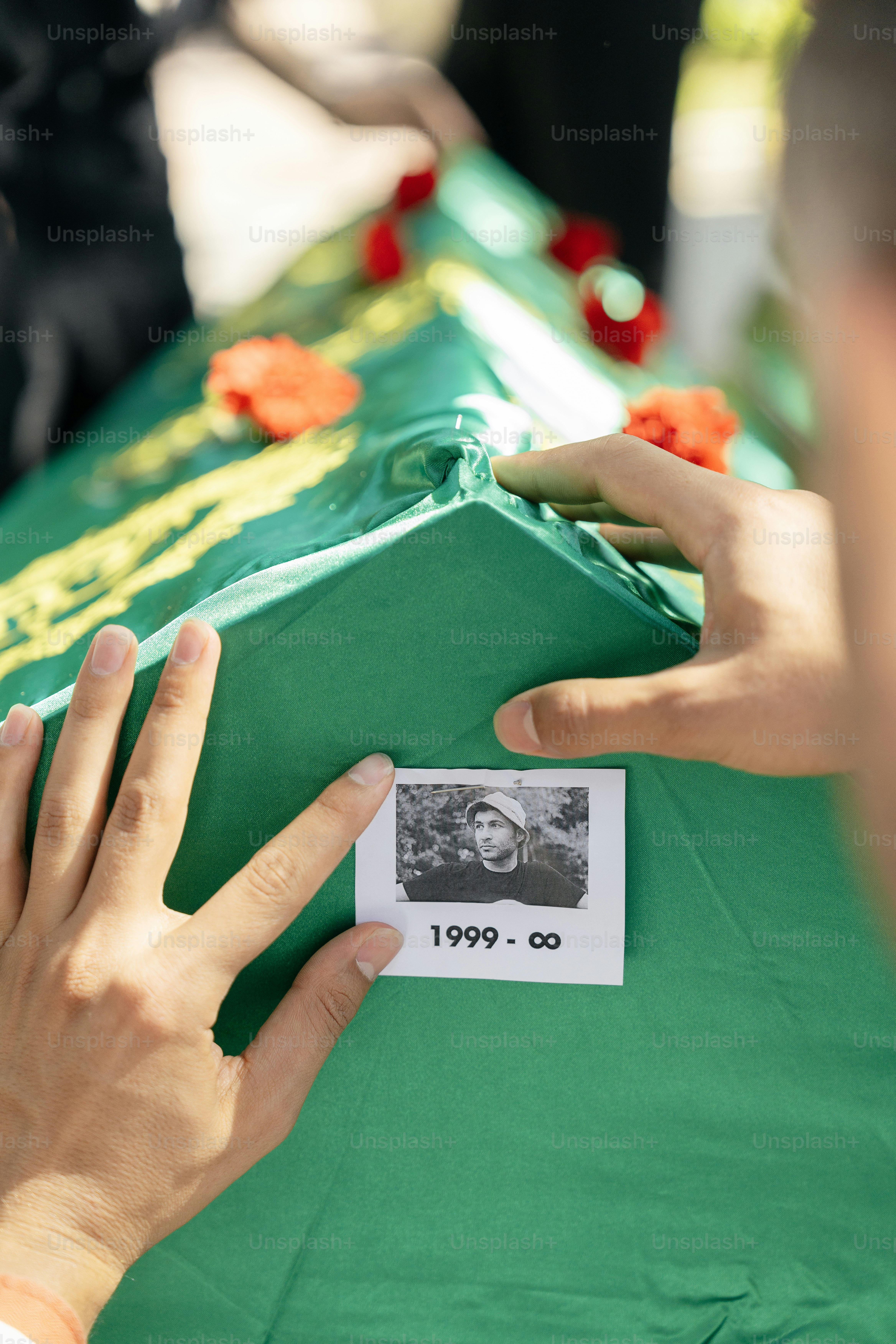 a person placing a picture on a green box