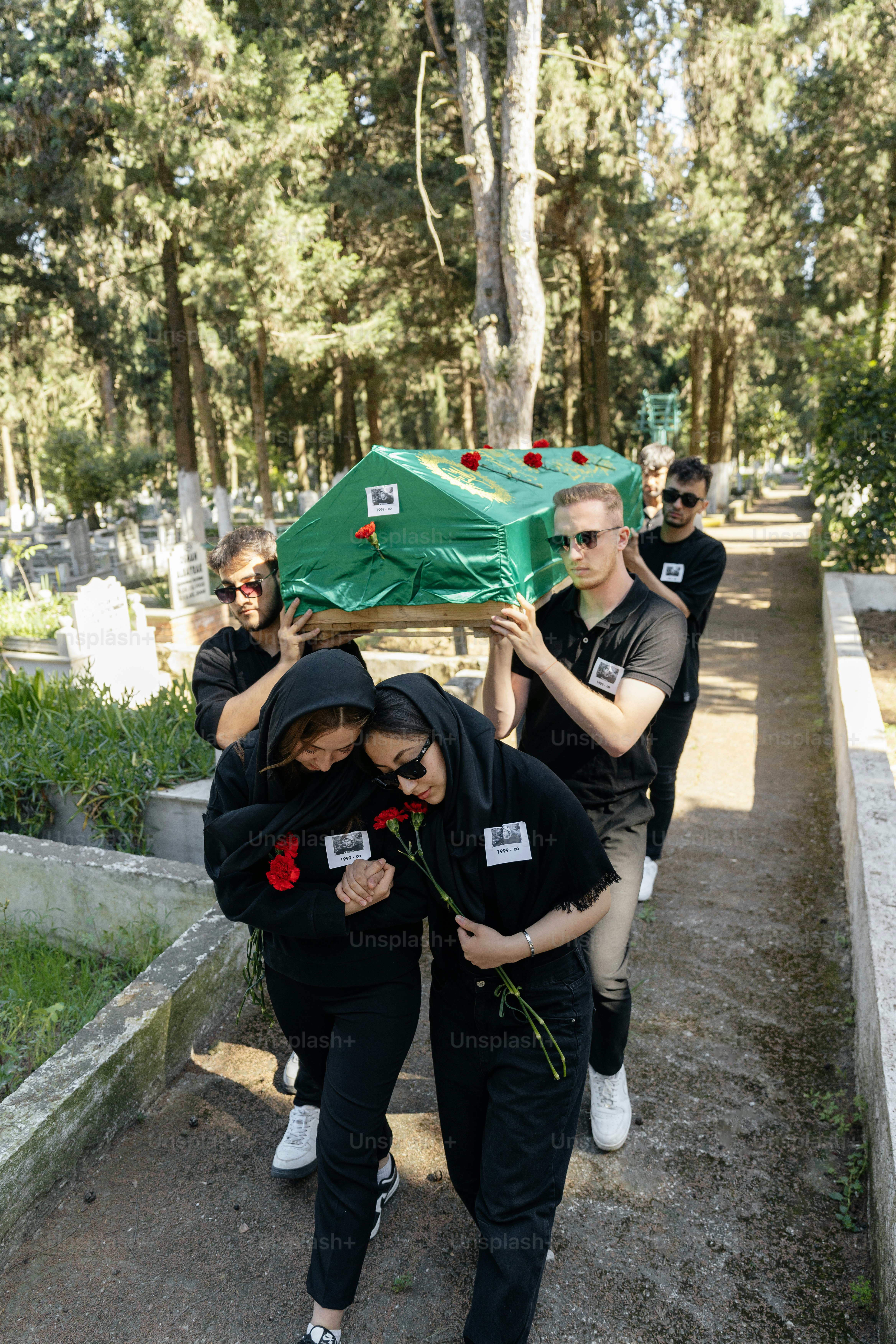 a group of people carrying a green object over their heads