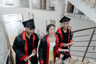 a group of graduates walking down a flight of stairs