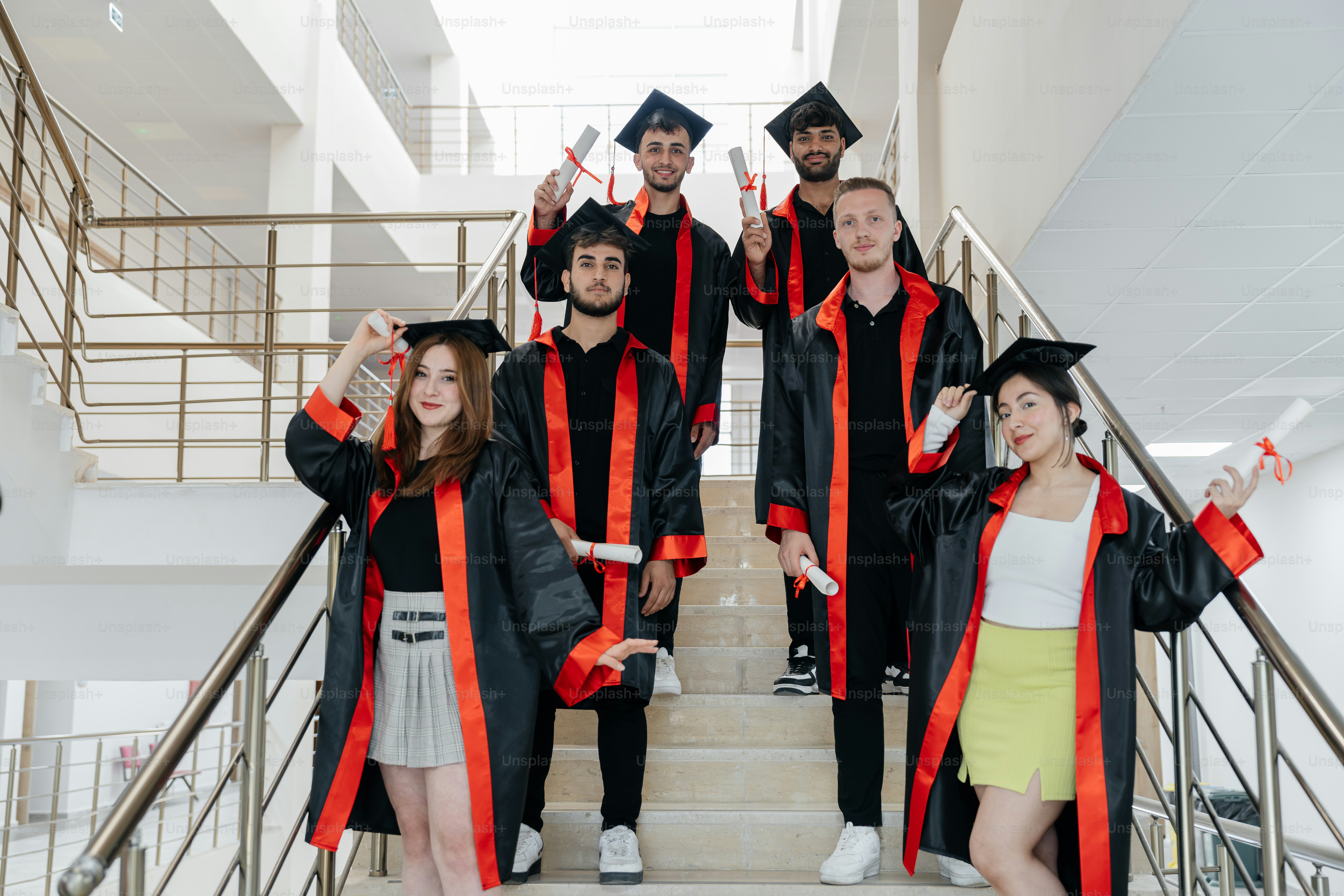 a group of people in graduation gowns posing for a picture