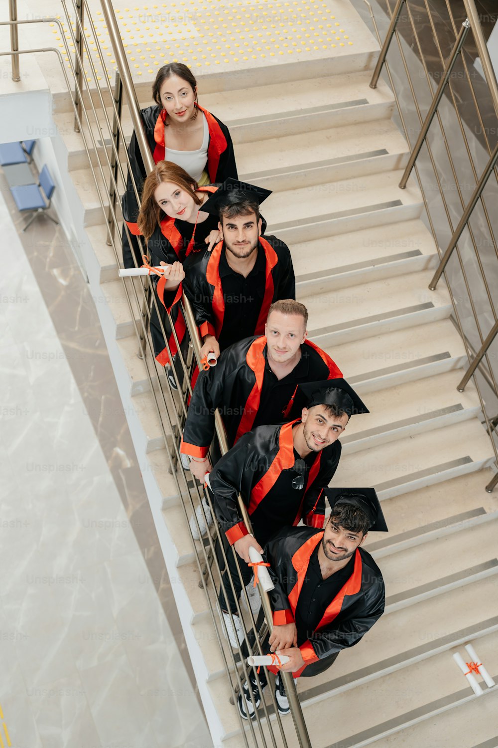 a group of people standing on top of a stair case