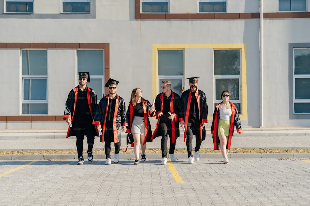 a group of people in graduation gowns walking down a street