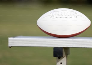 a close up of a football sitting on top of a bench