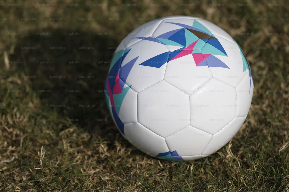 a close up of a soccer ball in the grass