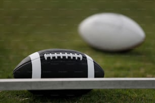a football sitting on top of a field next to a metal pole