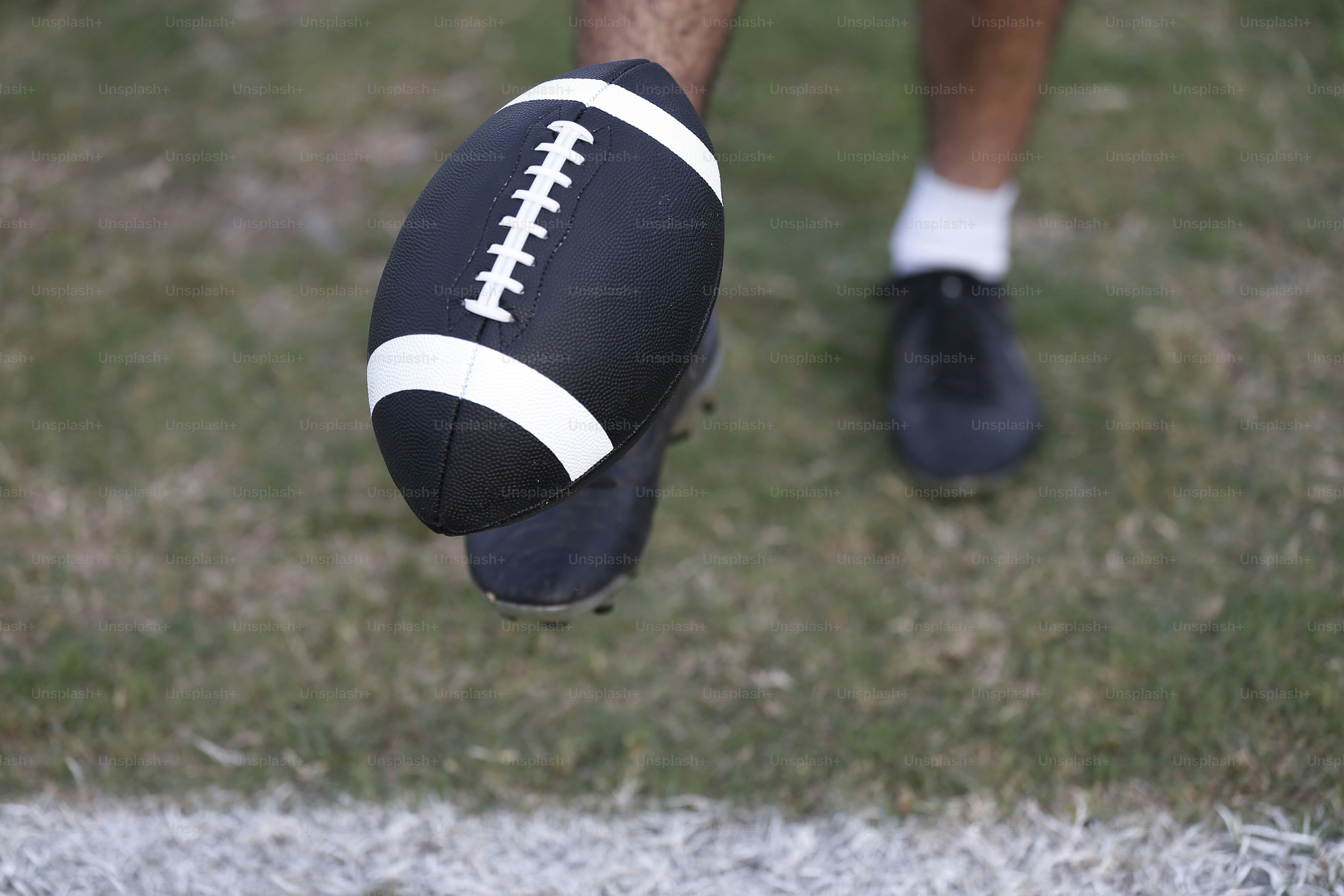 a close up of a person holding a football
