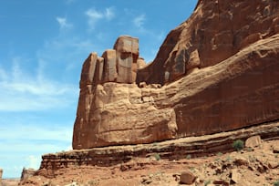 a large rock formation in the middle of a desert