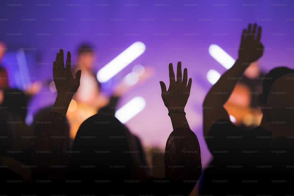 a group of people with their hands up in the air