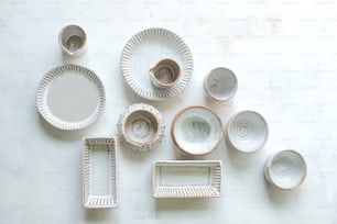 a table topped with lots of white dishes