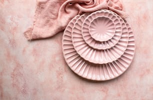 two pink plates sitting on top of a table