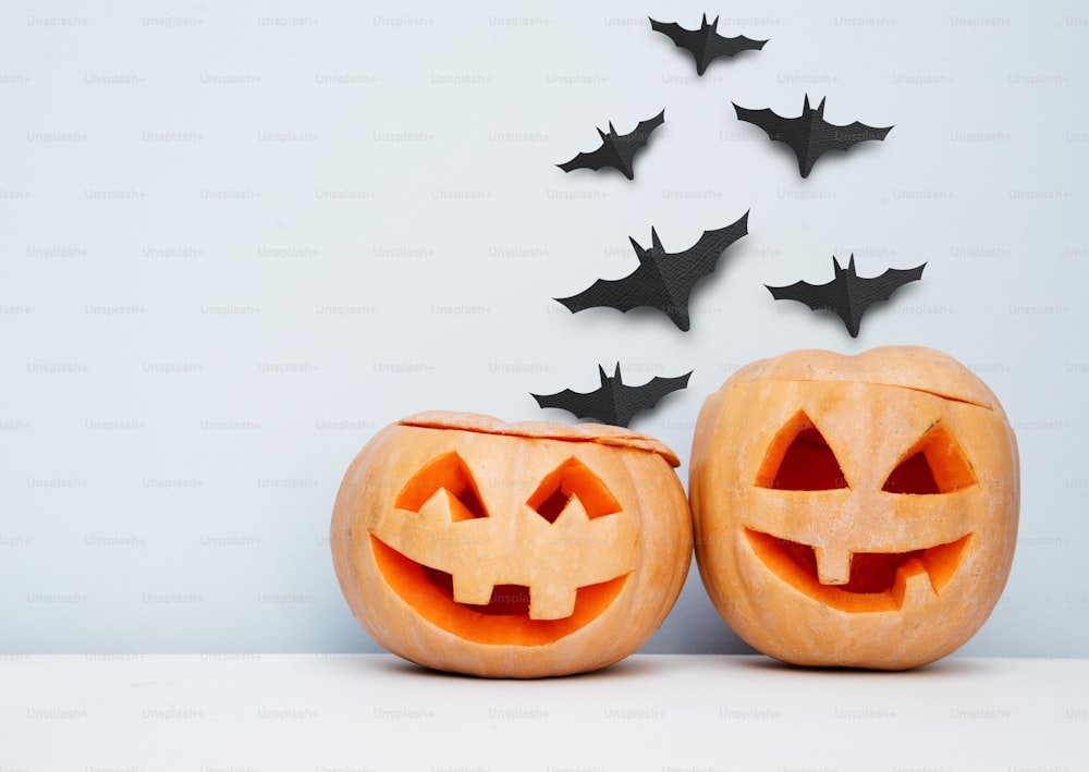 Halloween craft background with pumpkins and flying bats.