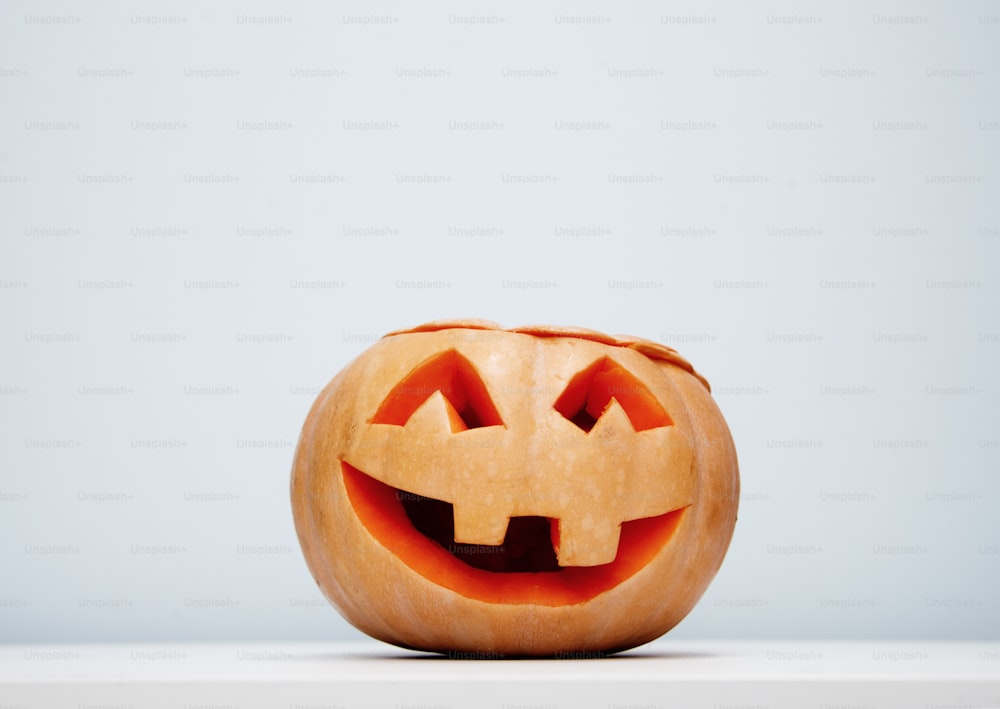 Halloween craft background witha single pumpkin smiling.