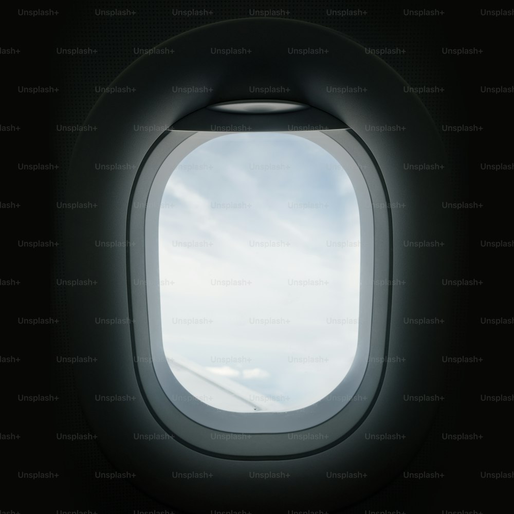 비행 중 비행기 현창 창문을 통해 밖을 내다보고 있습니다.