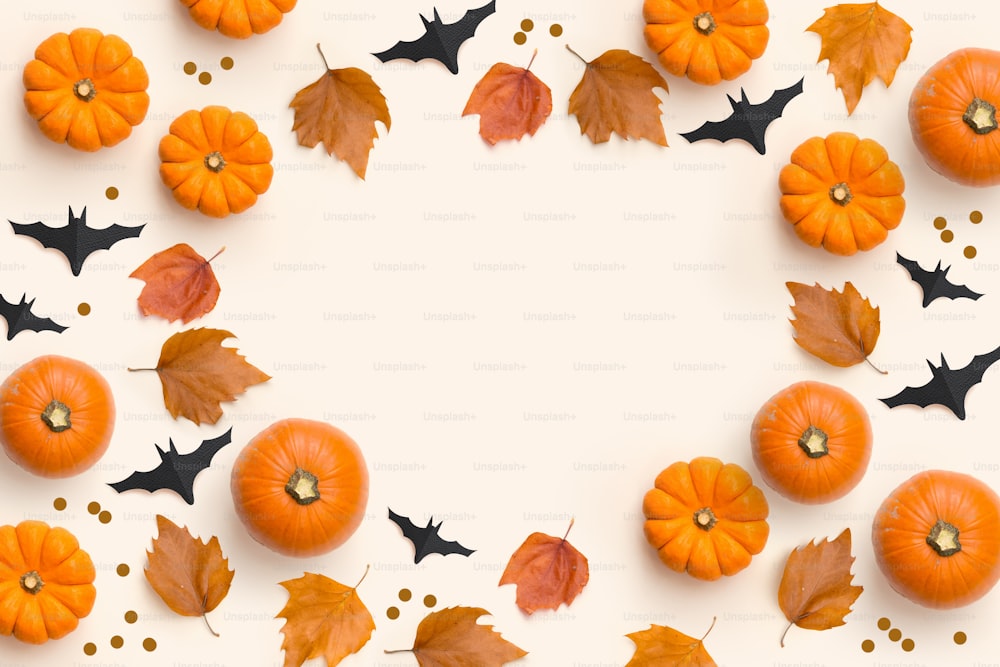 Autumn fall  contemporary background composition with pumpkins and leaves with room for text.