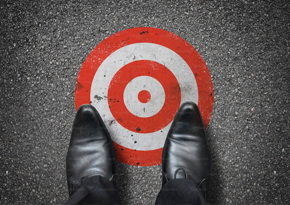 A businessman looking down at a target. Business concept.