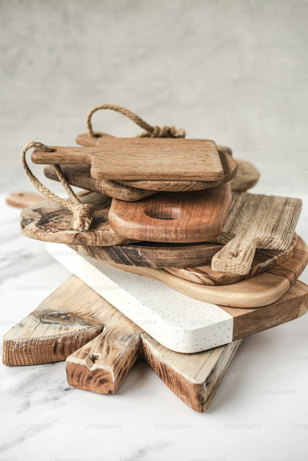 a pile of wooden cutting boards sitting on top of a table