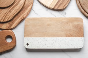 a wooden cutting board sitting on top of a white counter