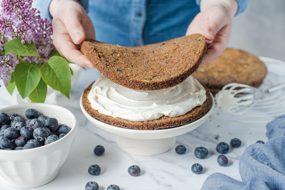 a person is spreading whipped cream on a piece of bread