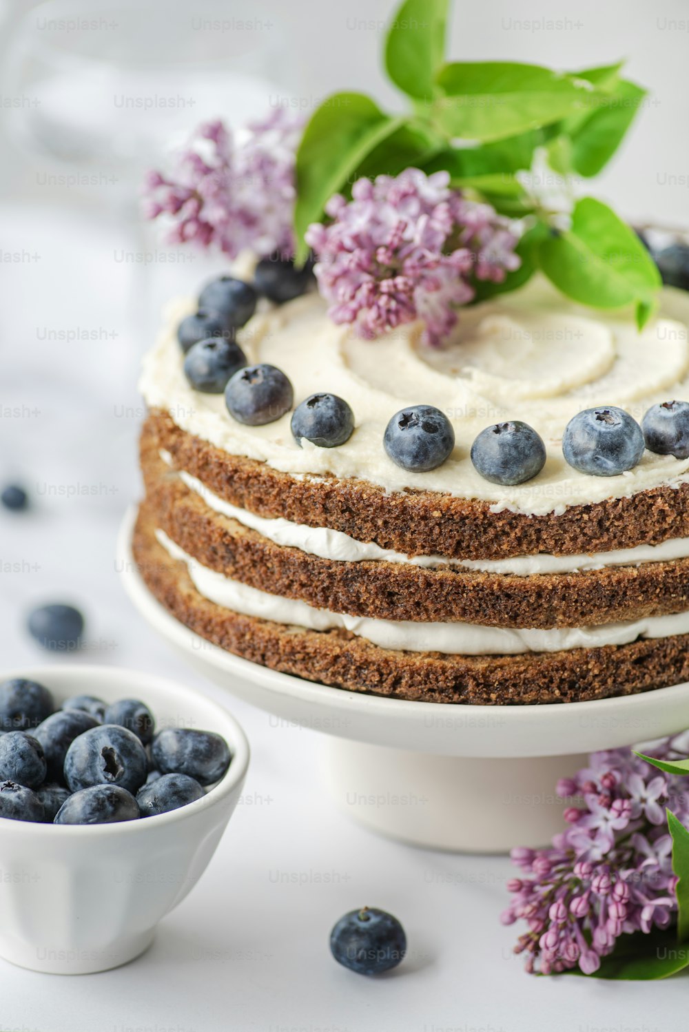 a close up of a cake on a plate with blueberries