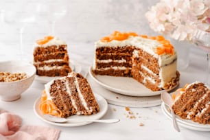 uma fatia de bolo de cenoura com cobertura branca em um prato