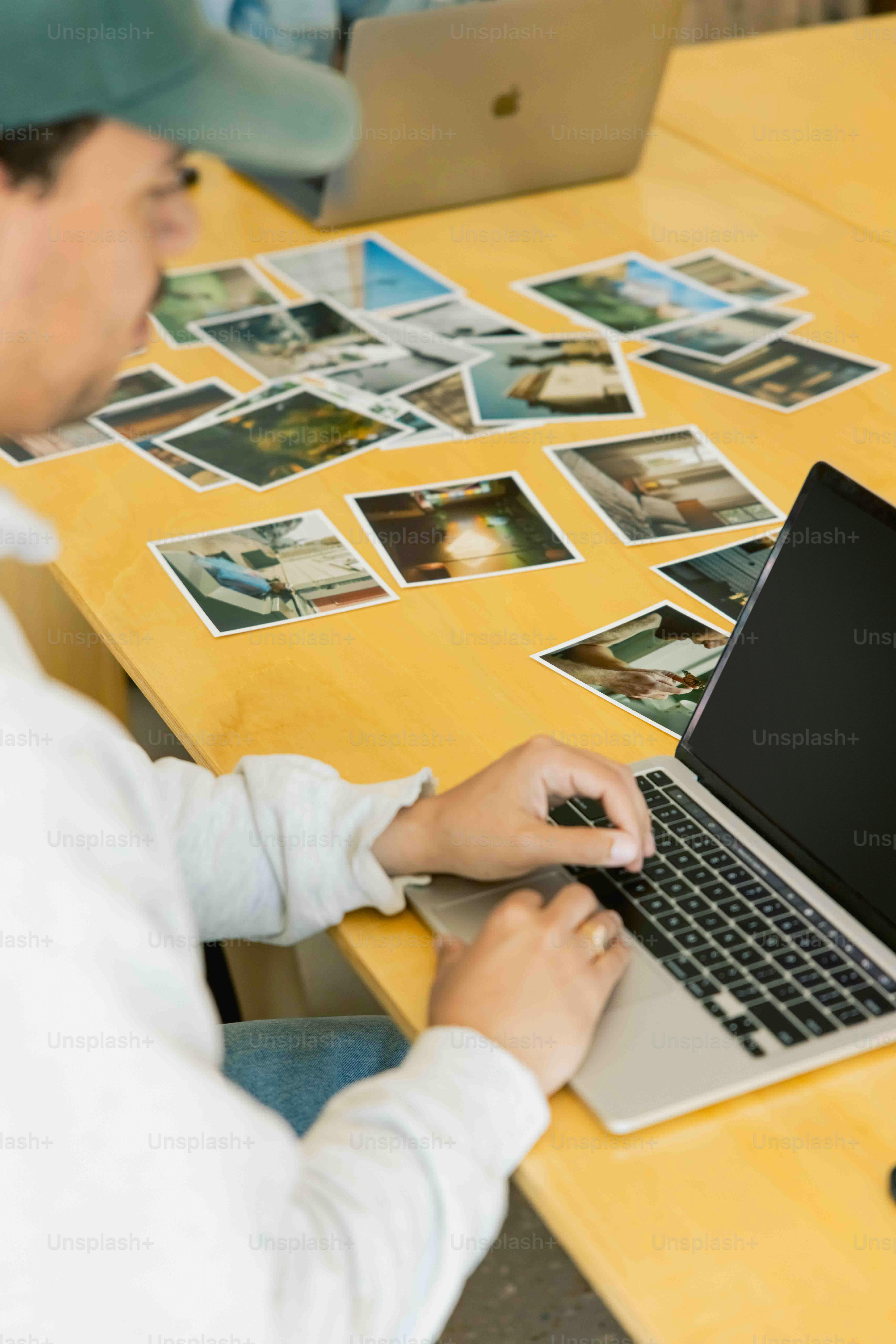 a man sitting at a table using a laptop computer