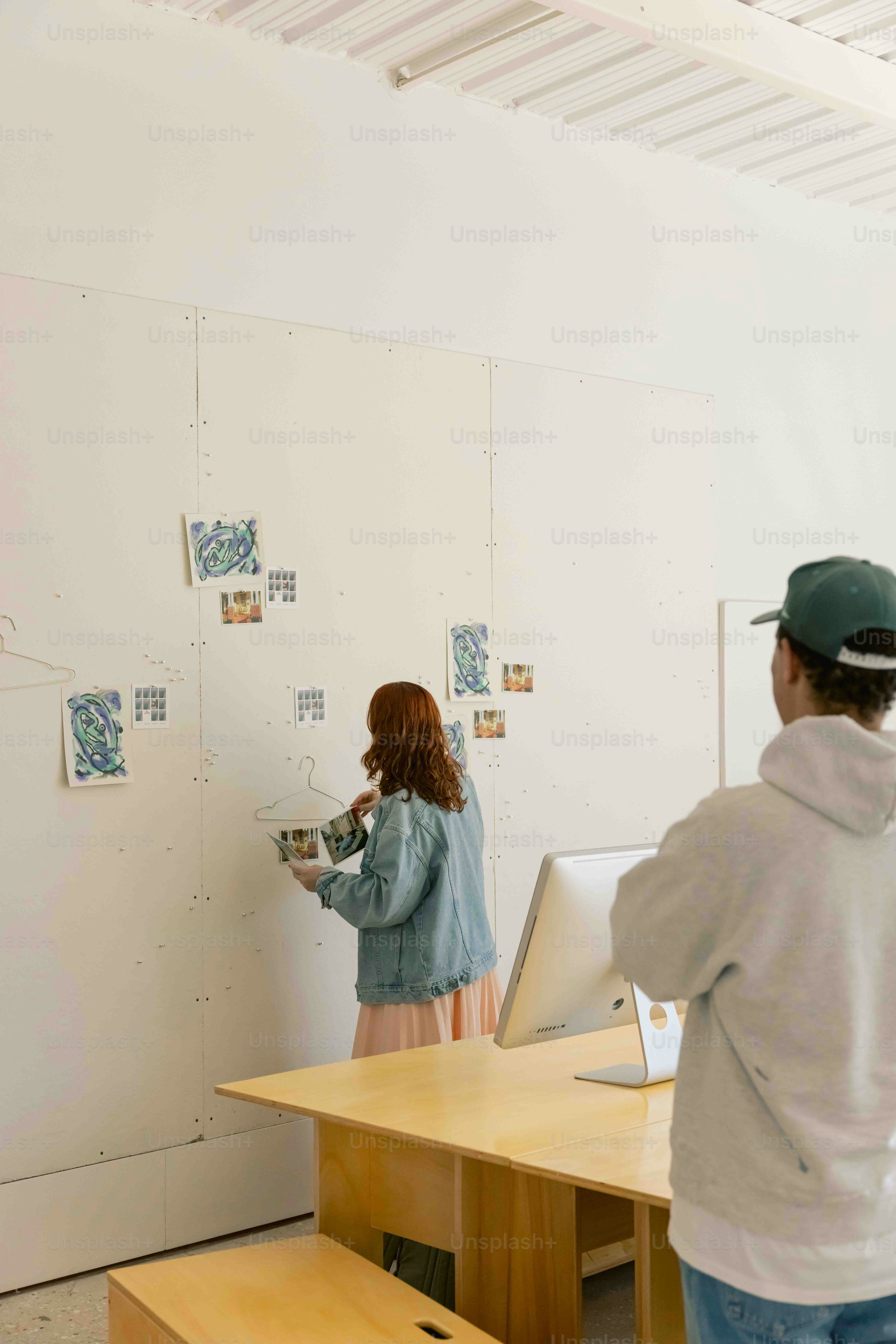 a man and a woman standing in front of a desk