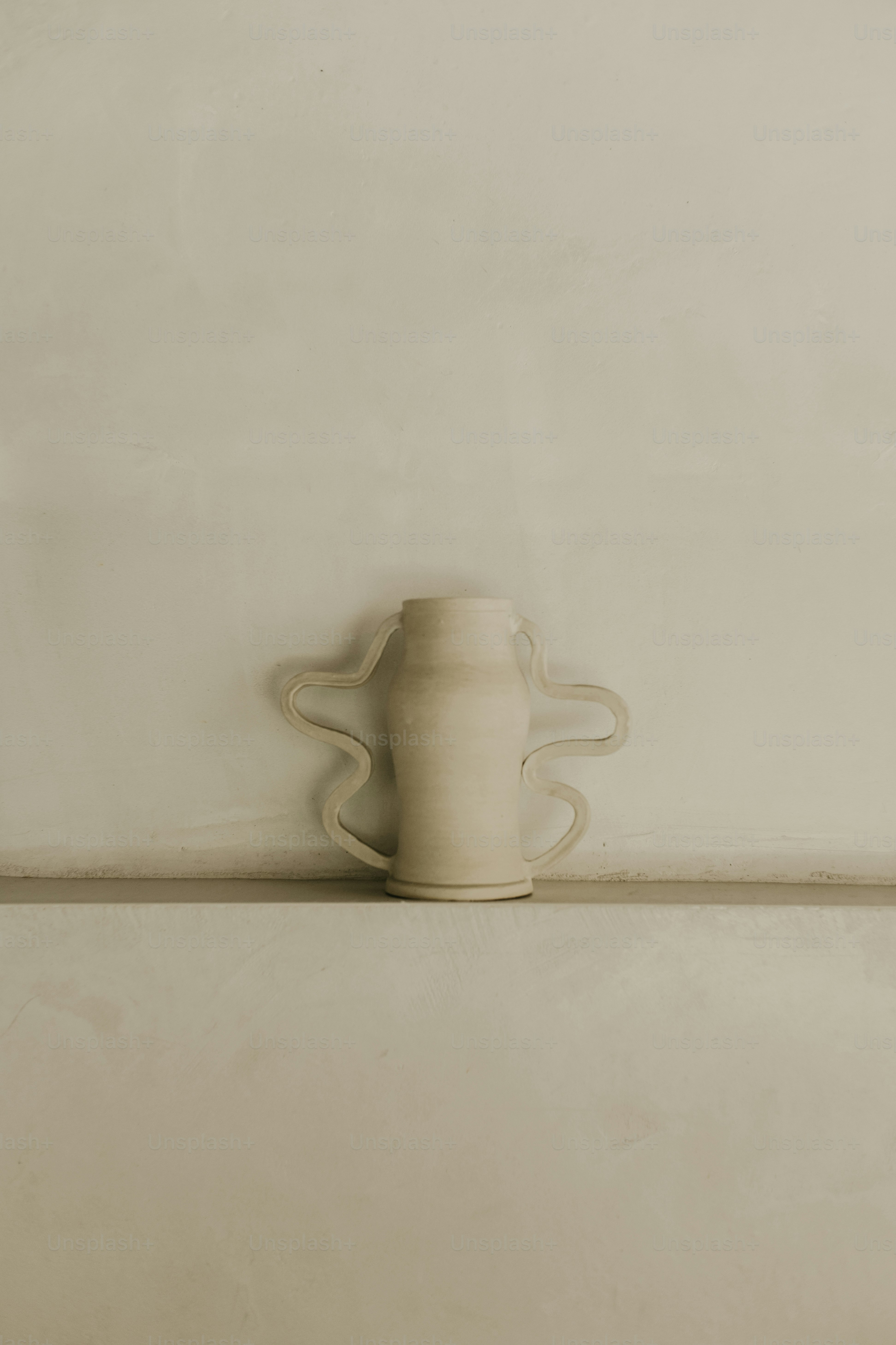 un vase blanc posé sur une étagère