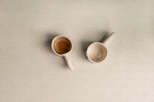 two cups of coffee sit on a table