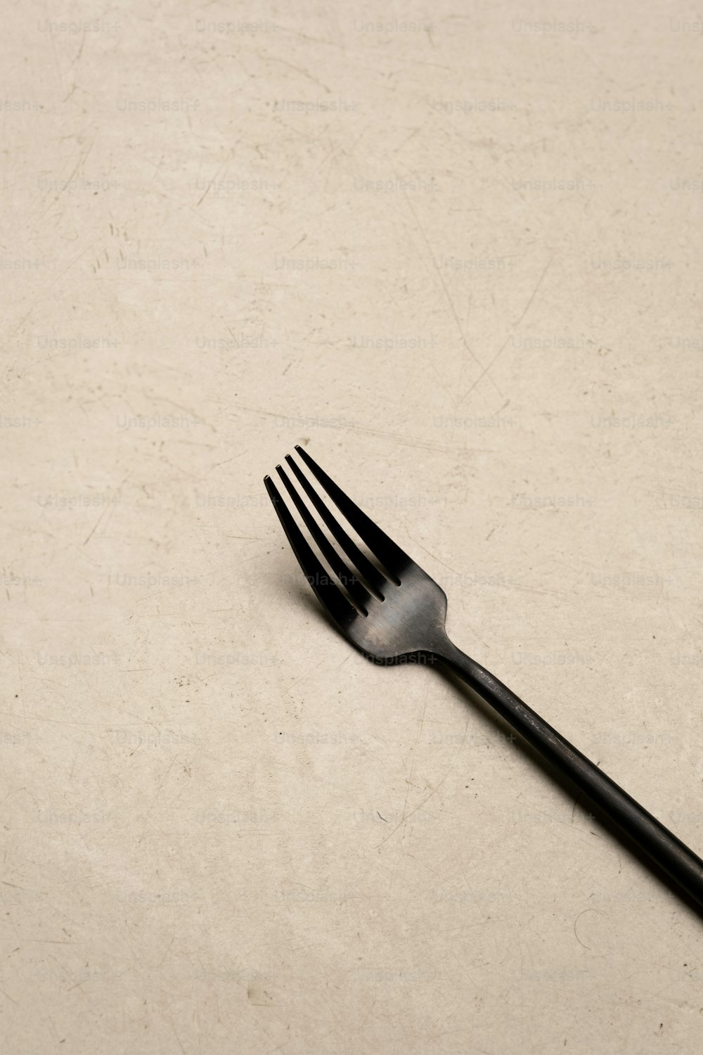 a close up of a fork on a table