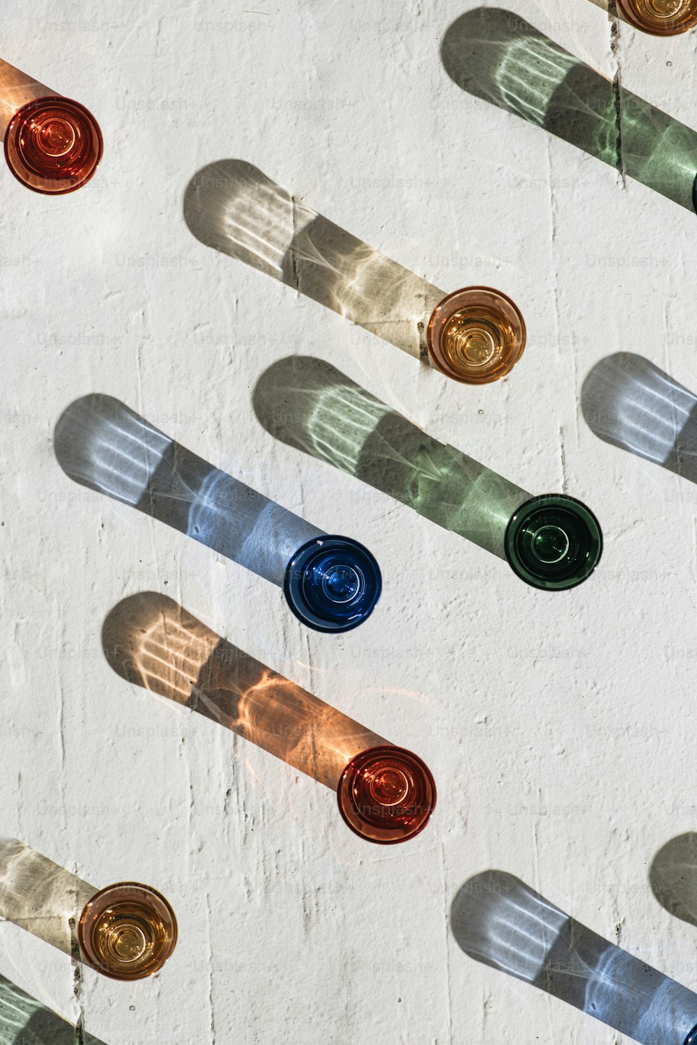 a group of bottles of wine sitting on top of a white wall