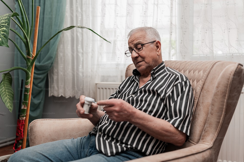 a man sitting in a chair holding a remote control