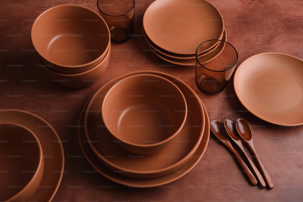 a table topped with lots of brown dishes
