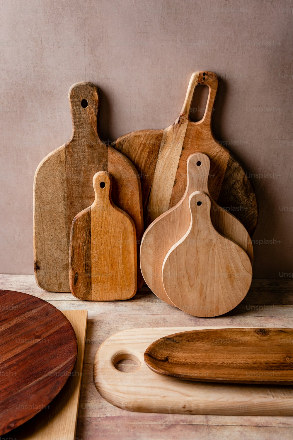 a group of wooden cutting boards sitting on top of a table