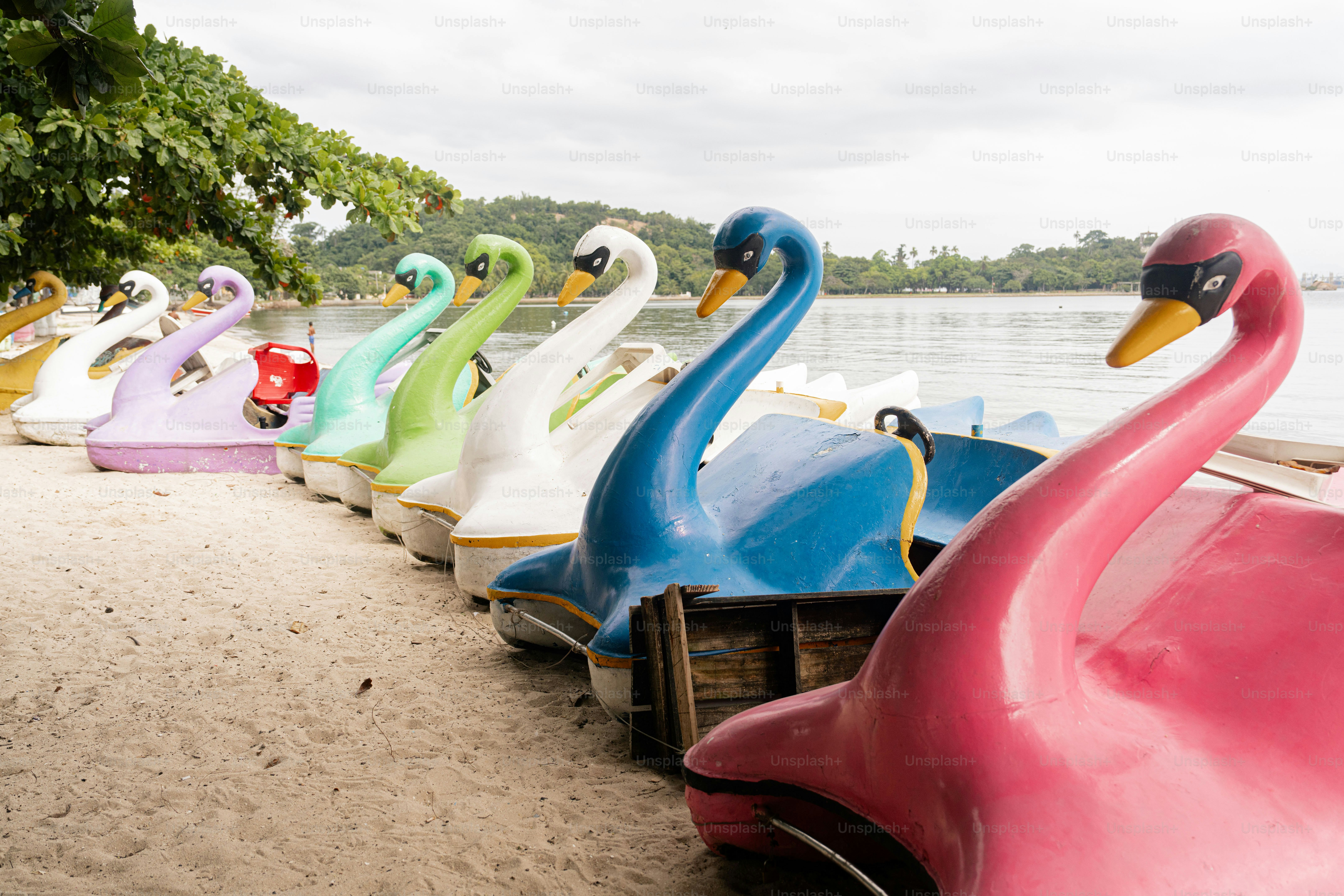 a row of colorful boats sitting on top of a beach