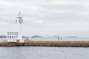 a couple of people that are walking by a clock tower