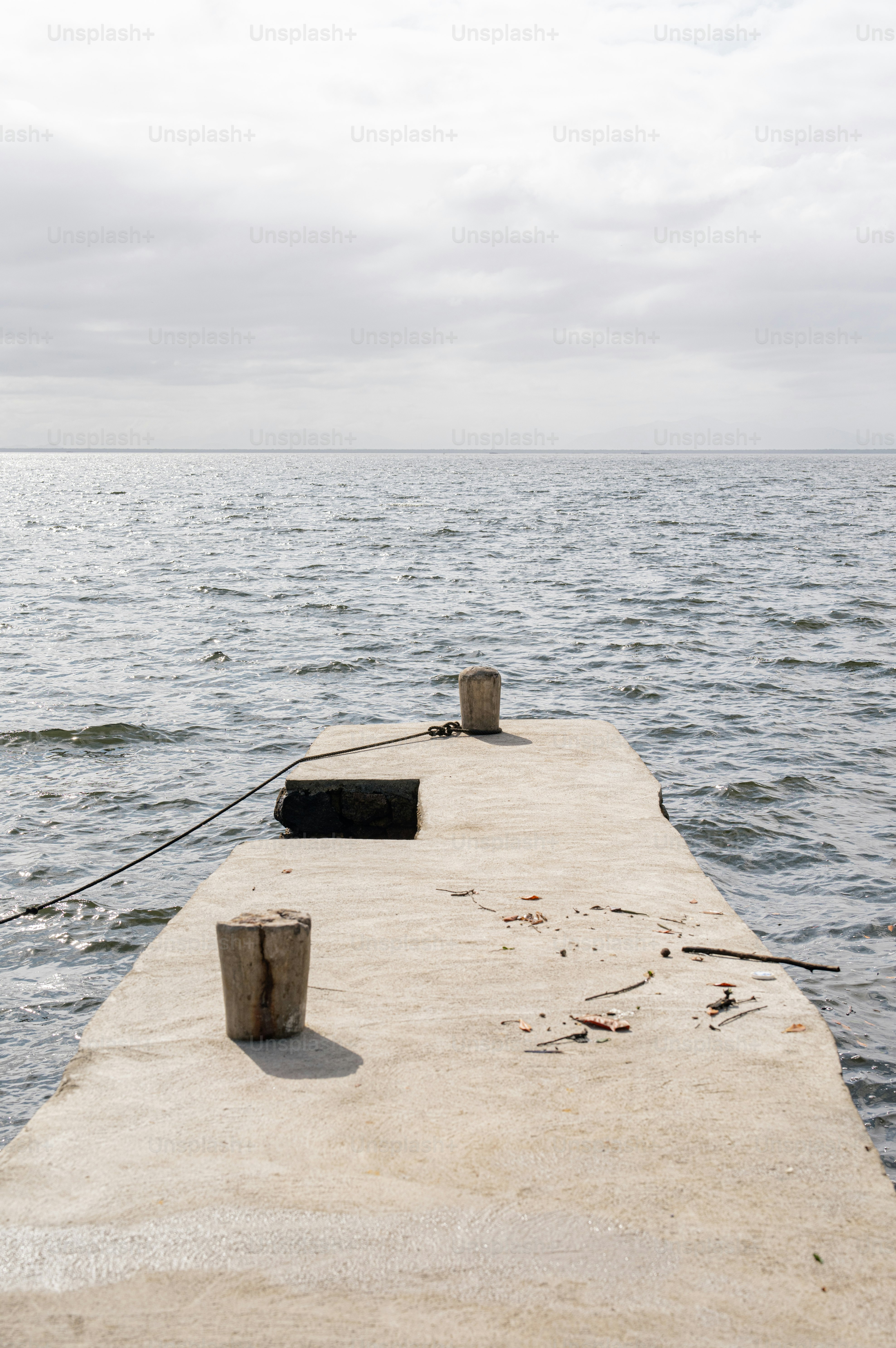two buckets sitting on the end of a pier
