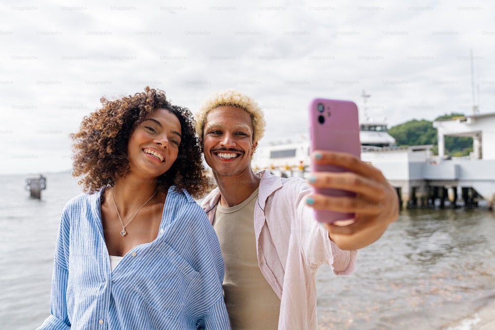 a man and a woman taking a picture with a cell phone