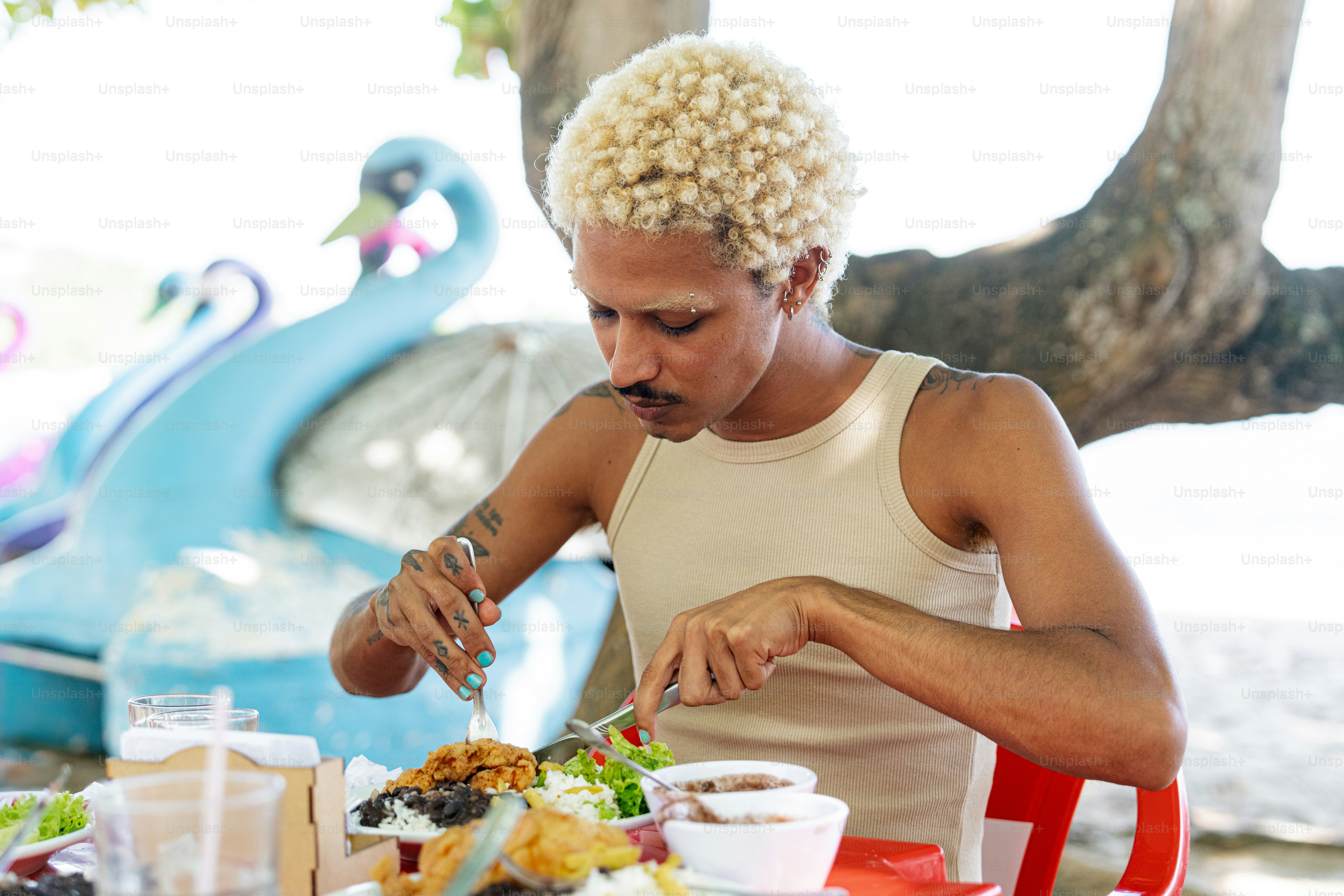 a man sitting at a table with a plate of food