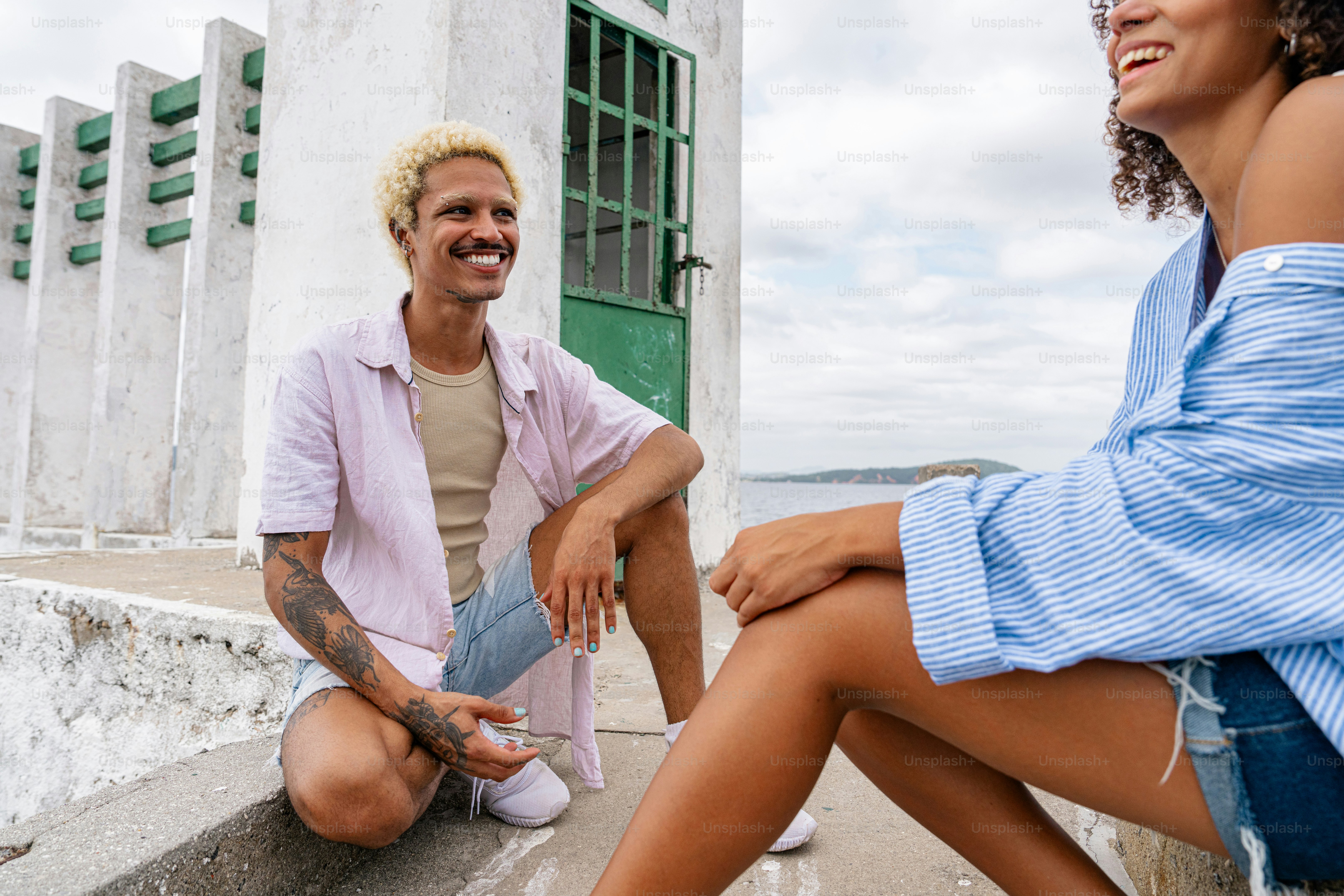 a man sitting on the ground next to a woman