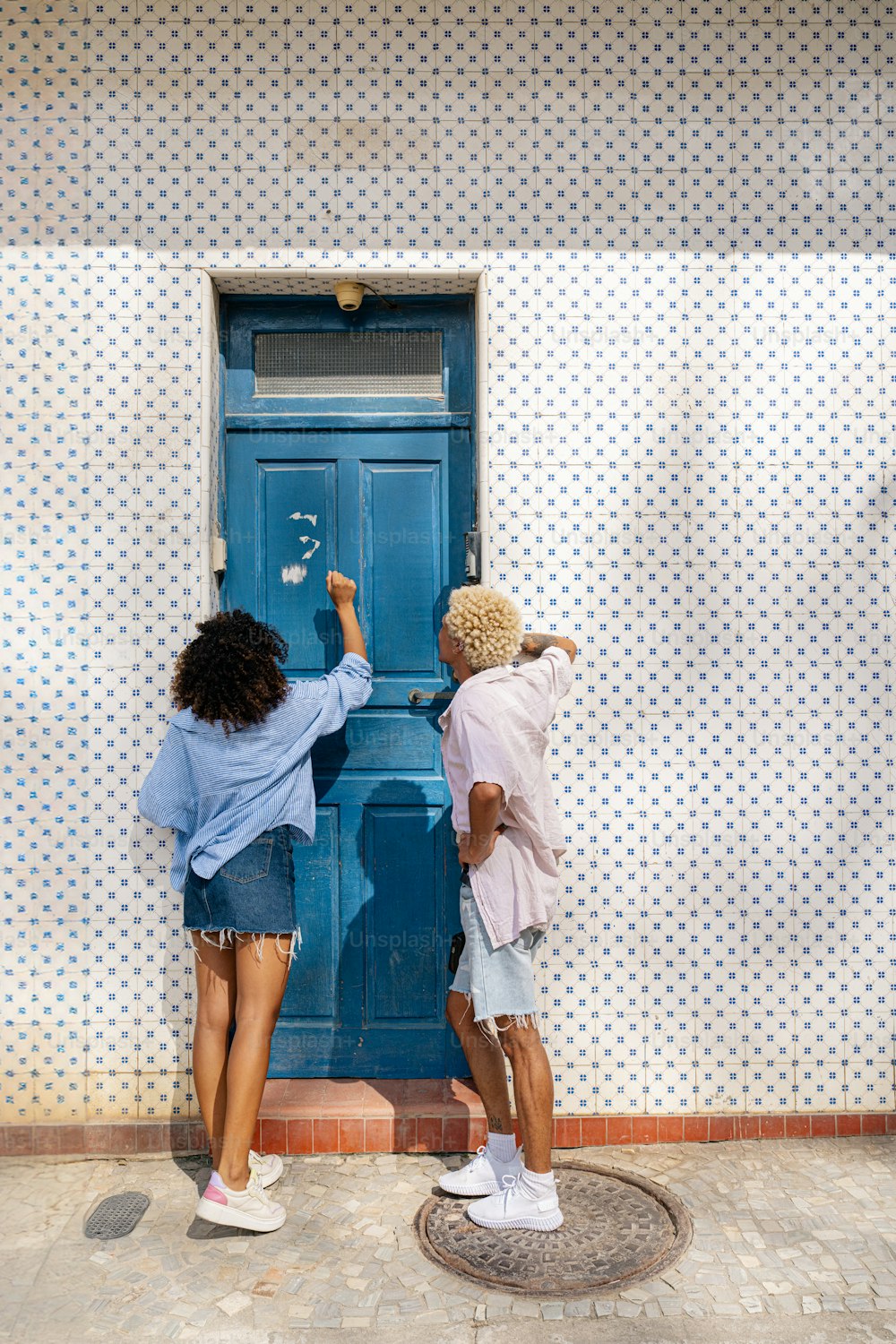 a couple of people that are standing in front of a door