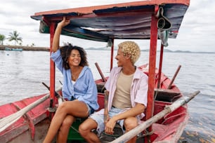 a man and a woman sitting in a boat on the water