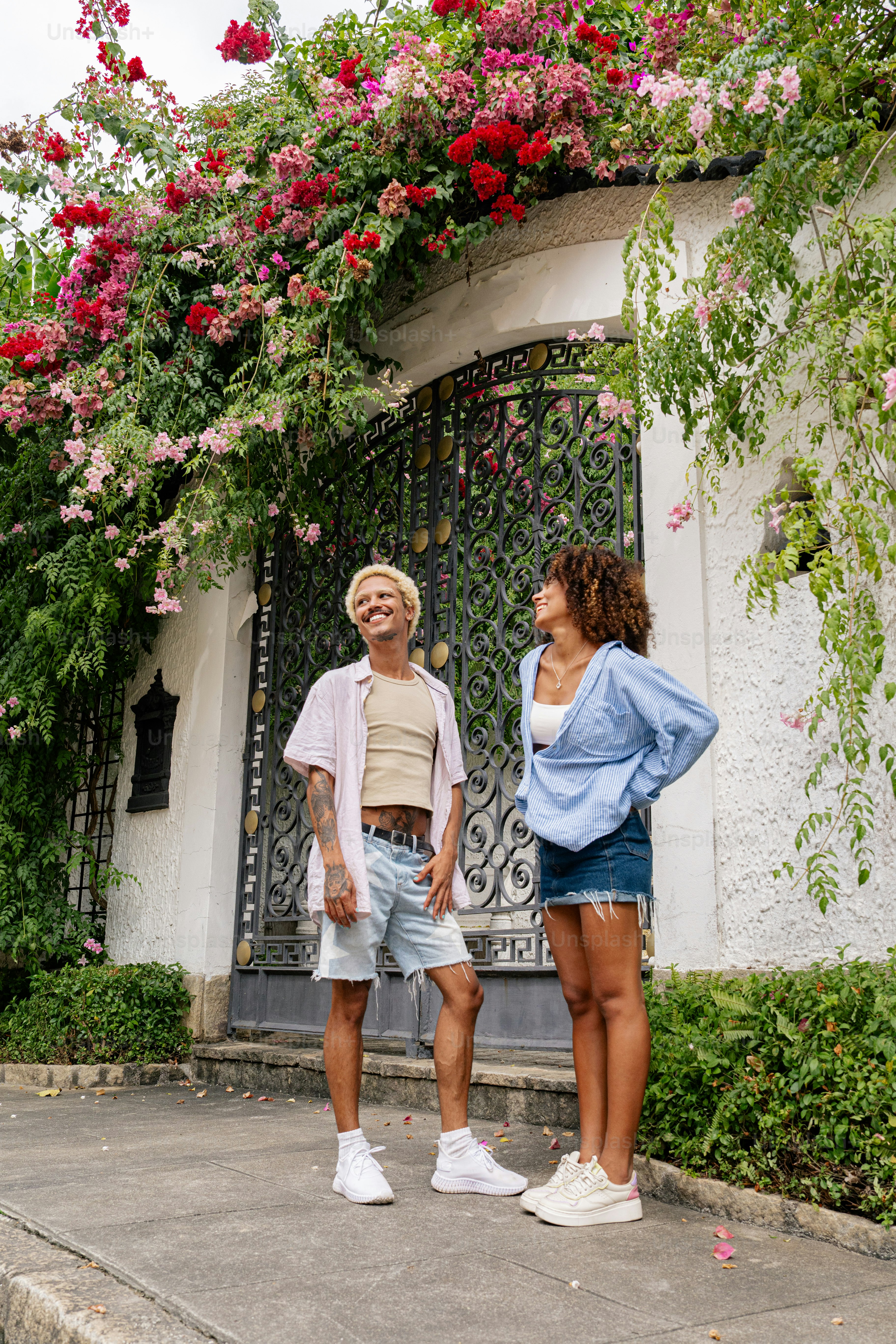 a man and a woman standing in front of a building