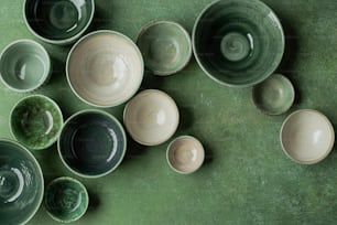 a group of bowls sitting on top of a green table