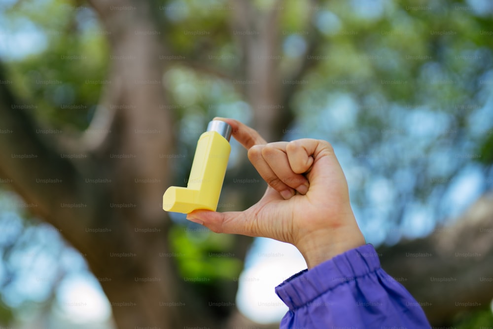 a person holding a yellow object in their hand