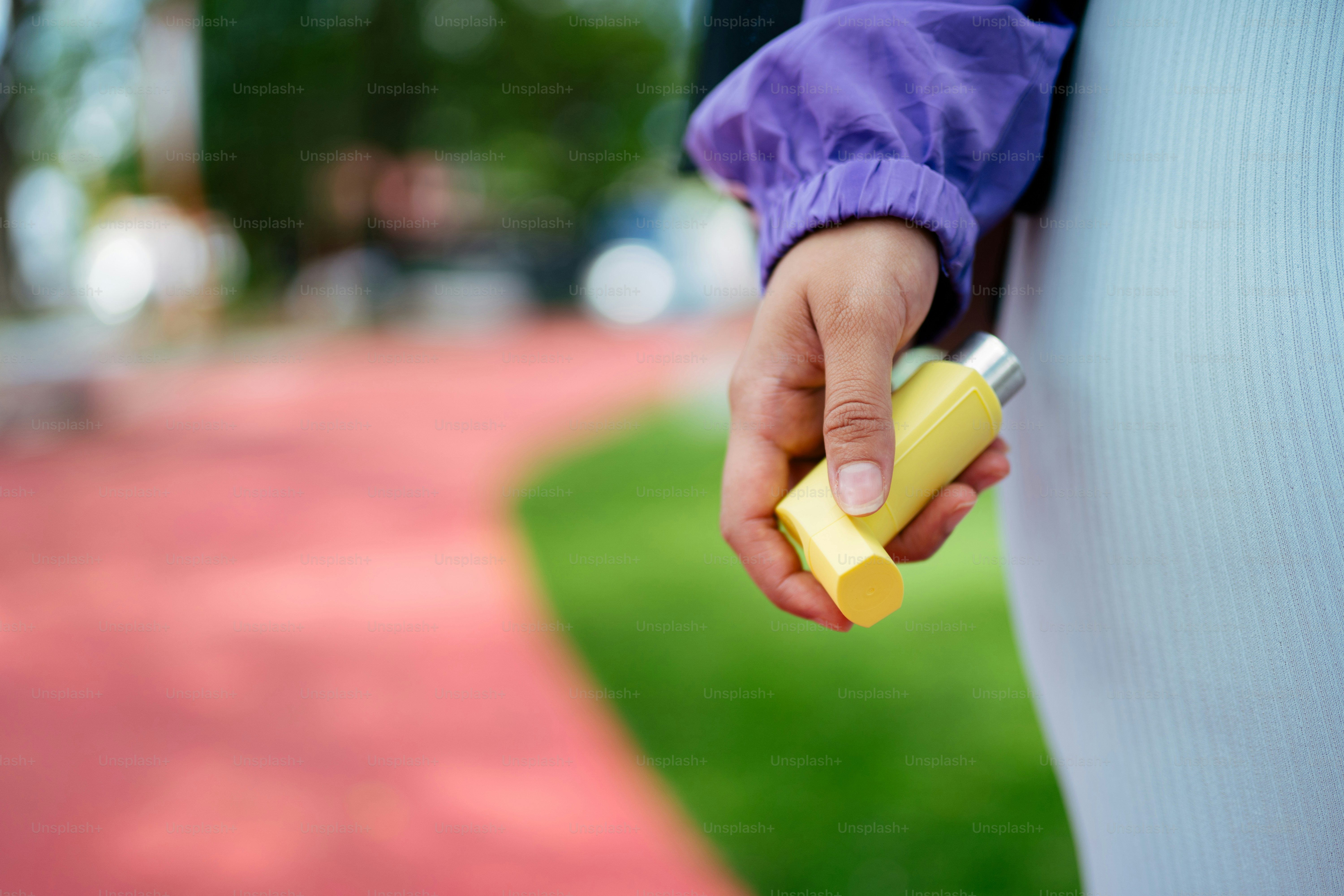 a person holding a yellow object in their hand