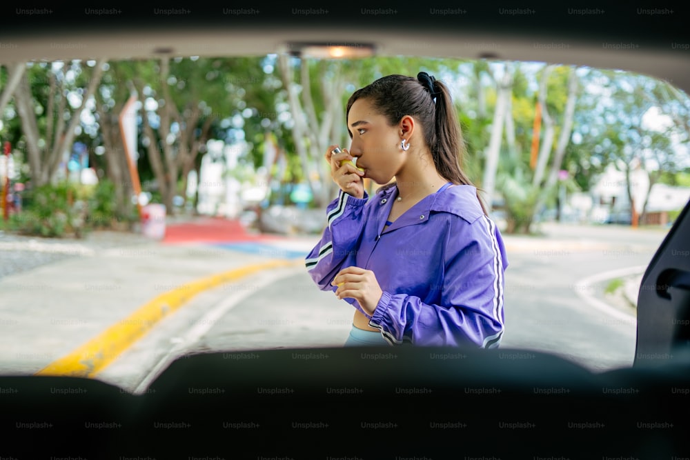 uma mulher fumando um cigarro no banco de trás de um carro